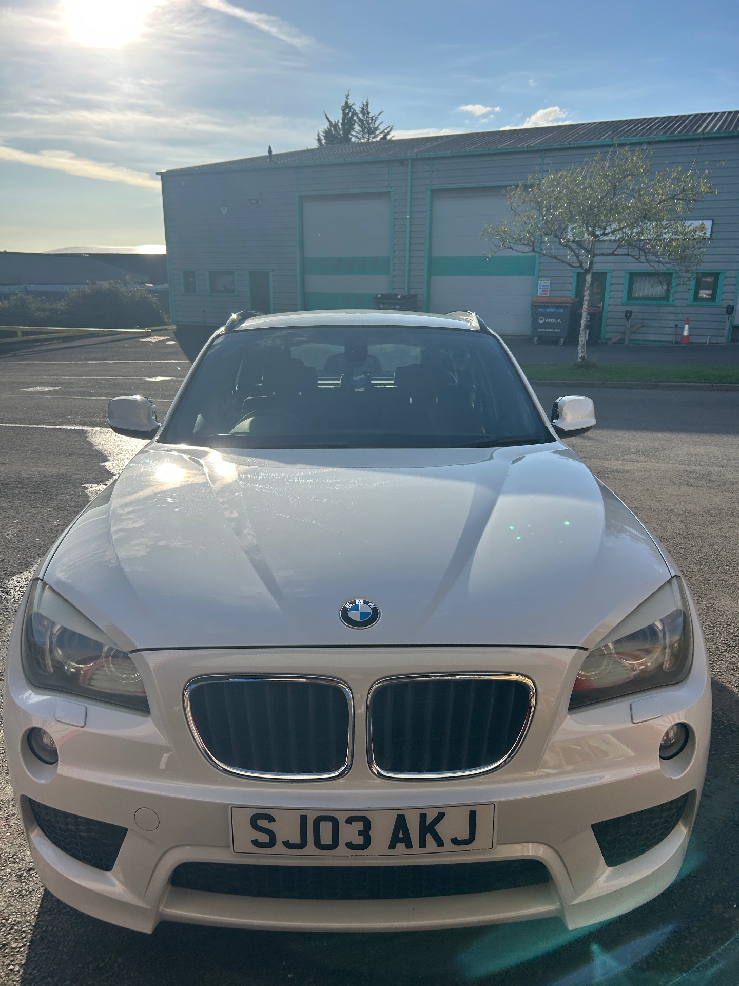 Front view of a white BMW after detailing by PressureWashPyle
