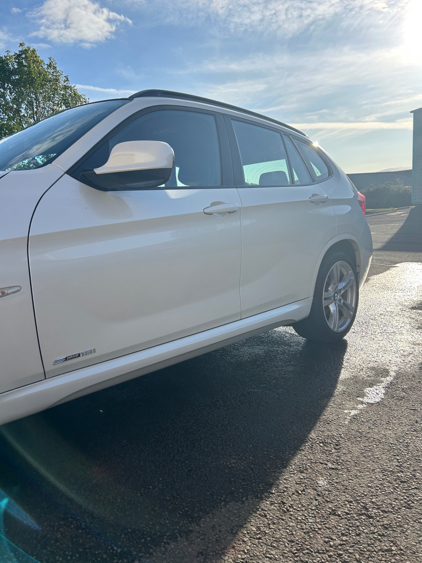 Glossy driver-side finish on the detailed BMW