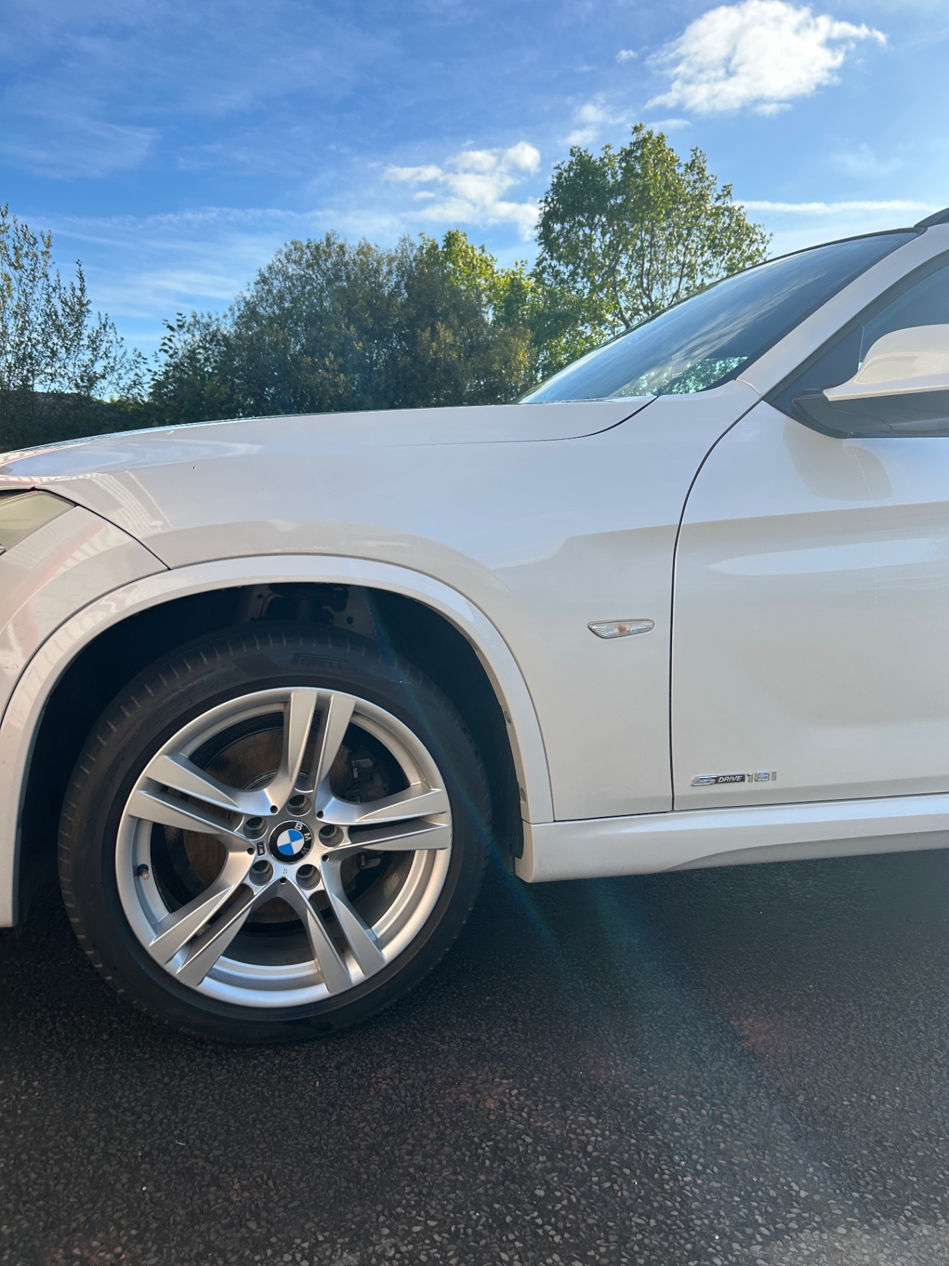 Clean BMW front wheel and polished white bodywork