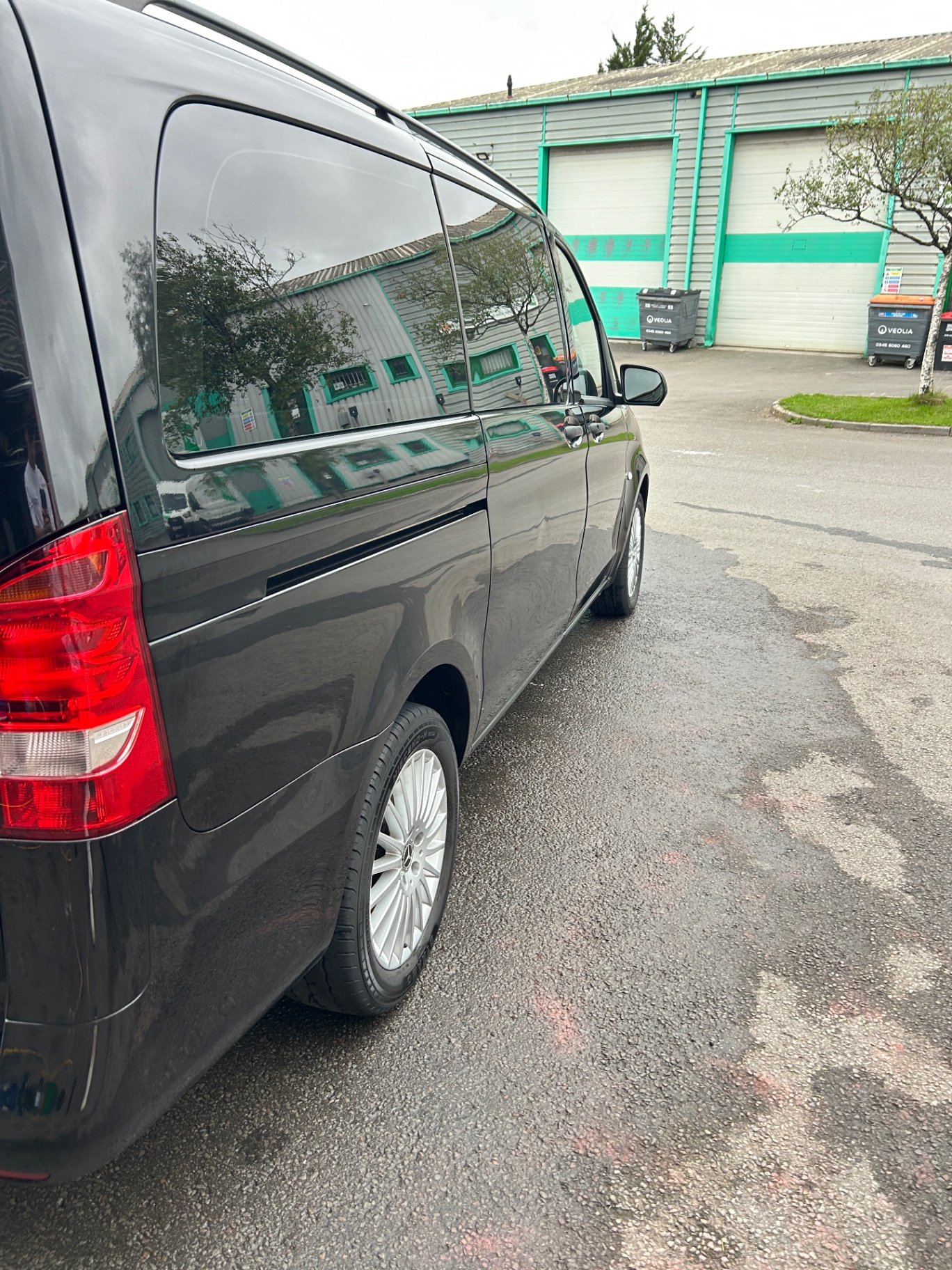Rear side view of the freshly detailed black Mercedes Vito